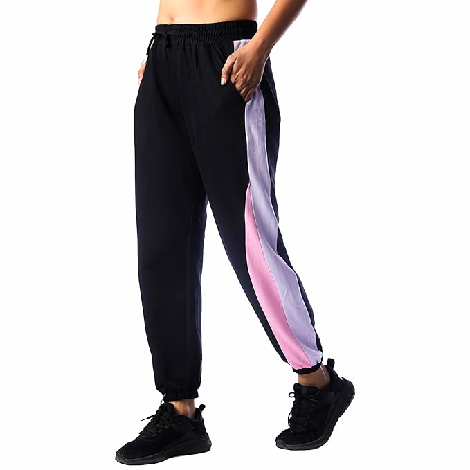 Women wearing black mid rise cotton joggers with pink and grey side stripes for dance